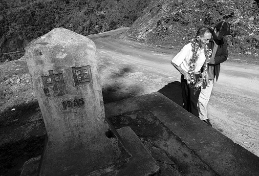 １０月１２日，中缅边境第四号界碑旁，在本报记者的搀扶下，李锡全按照当年原路返回了祖国。图／记者王旻