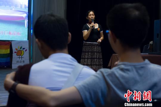 图为一对男同志在听取“同志妈妈”吴幼坚讲述同志故事。 刘冉阳 摄