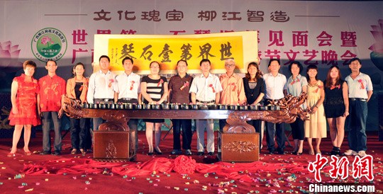 5月31日晚,在“世界第一石琴”揭幕见面会暨2013年广西柳江荷花文化旅游节文艺晚会现场,少数民族美女表演石琴演奏。中新社发 黄冬 摄