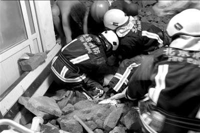 由于泥土砖块离被埋女子太近，消防人员最后采用手刨的方式救援。京华时报通讯员 王国帅 摄