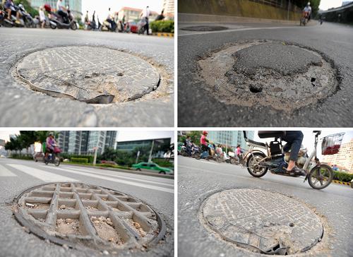 6月14日,在广西南宁市仙葫大道,市民从一处正在修建的下水道井口旁经过。新华社记者 周华 摄