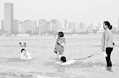 家长无视警告汉江中牵着绳子带小孩游泳(图)
