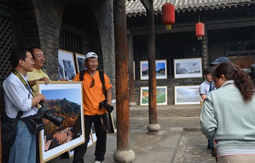 2013平遥国摄影大展石膏山国际摄影大赛优秀作品展上,游客合影留念。