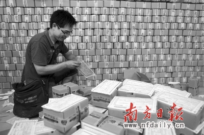 快递员阿棠在给收回来的快件贴上单据。 郭志军 摄