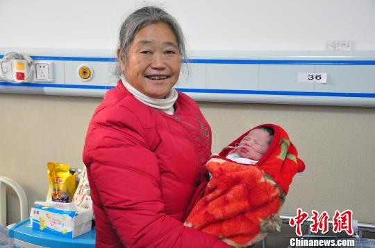 孩子奶奶抱着被大家救下的孙女 杨楚群 摄