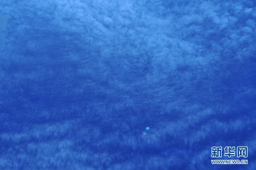 　　3月24日，中国空军两架伊尔-76运输机赴南印度洋搜寻马航失联客机，在任务区域发现疑似碎片目标。这是3月24日从高空拍摄的两块疑似碎片目标。 新华社记者黄书波摄 