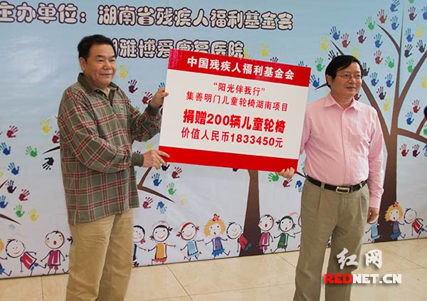 湖南省残疾人福利基金会理事长黄凤湘向在湘雅博爱康复医院移交价值183万元的便携式残疾儿童轮椅。