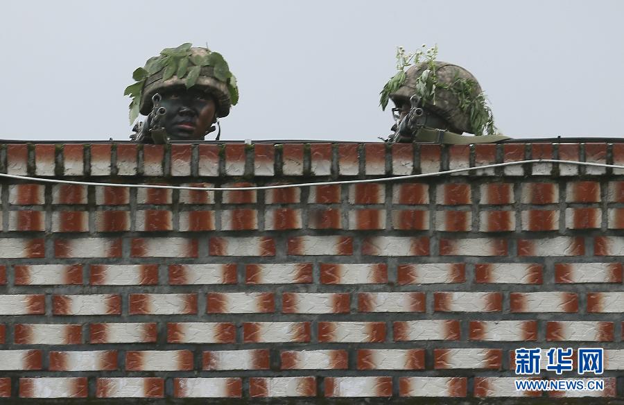  6月22日，在韩国江原道高城郡附近，士兵在房顶上进行警戒。