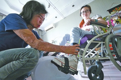 李友江帮助任静(右)做康复训练