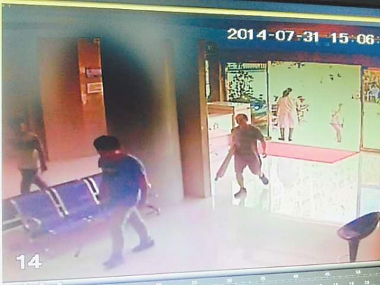 一名男子抱着一捆棍棒冲进医院