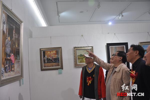 开幕式结束之后，参加活动的有关领导在仔细观摩展出作品。