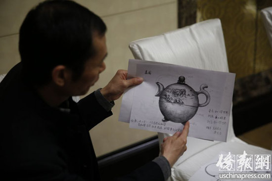汪成琼在北京中国大饭店向记者展示了多款赠送给2014年北京APEC会议各经济体领导人的紫砂壶设计图纸。 (图片来源:美国侨报)