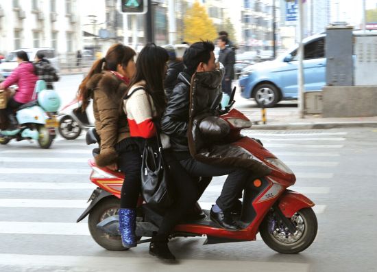 　昨日，一名骑电动车的男子带着两个女士快速行驶在经二路上