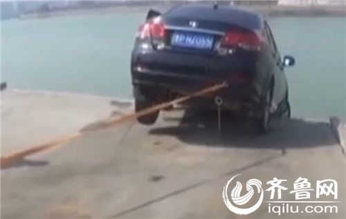 聊城一辆车停在斜坡,车子险些滑入湖内。(视频截图)