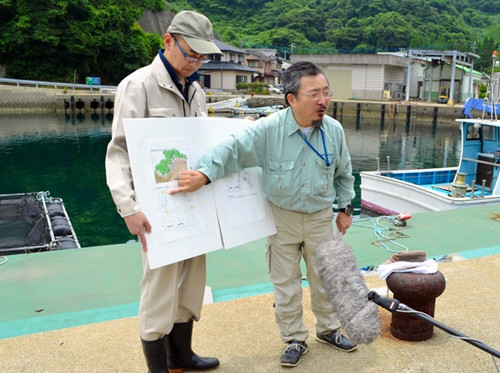 日本琉球大学教授池田荣史(右)说明调查情况。