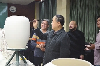 莫言在花瓶瓷坯上创作。