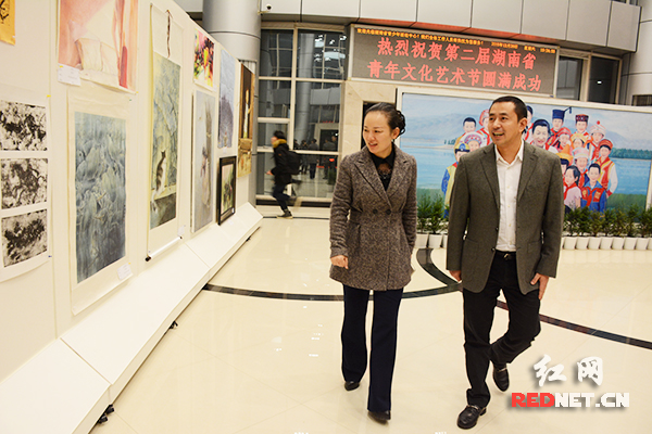 共青团湖南省委书记、党组书记汤立斌（右），湖南省文化厅党组书记、厅长李晖观看获奖作品。
