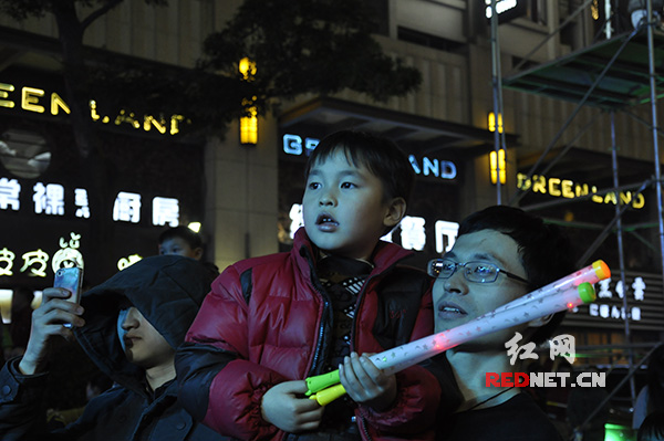孩子与父亲一起观看演出。