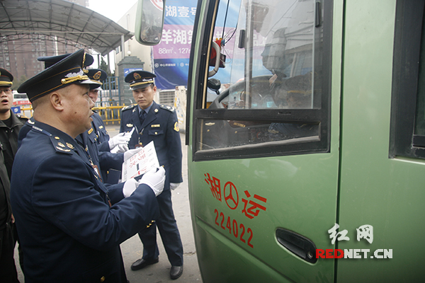 长沙县执法局执法人员对过往车辆进行检查。