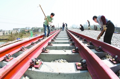 2月29日，长株潭城际铁路湘潭站,工人在铺设钢轨。 湖南日报记者 赵持 摄