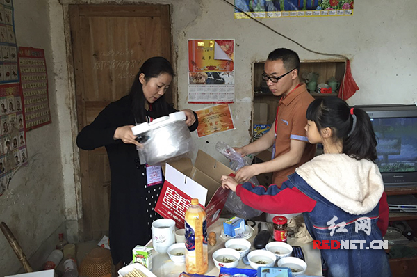 志愿者们拆封为朱湘雅家捐献的一口锅。