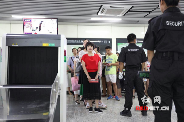 尚双塘站等待安检的乘客。