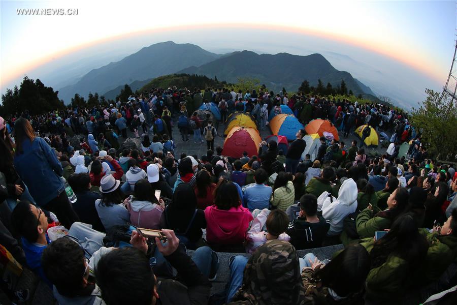 Tourists view sunrise at Hengshan Mountain scenic area in C China