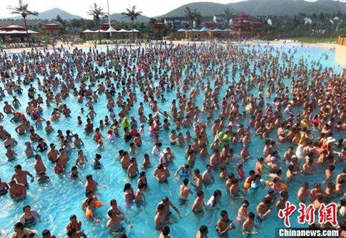 资料图：夏日气高温逼人，众多市民在水上乐园内的冲浪池戏水觅清凉。中新社发 泱波 摄