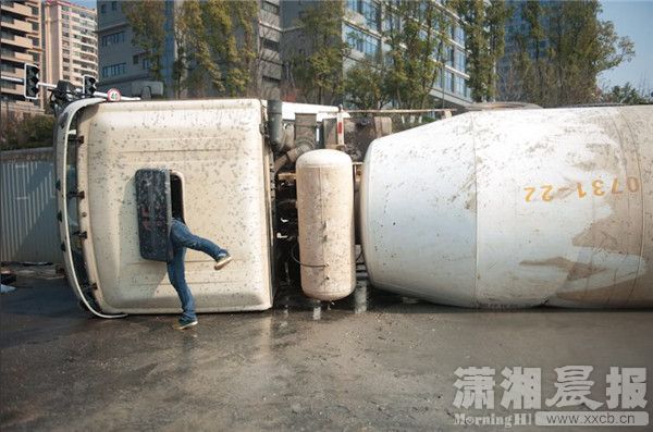 1月3日,湘府西路,侧翻水泥罐车的车主正试图从车内拿出发货单.